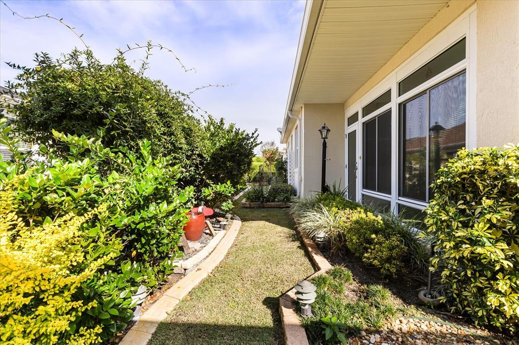 1424 Irwin Way The Villages, FL 32162 - Photo 27 of 28 a view of a house with a flower garden