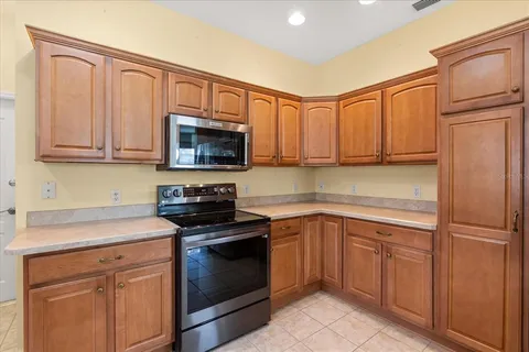 a kitchen with cabinets stainless steel appliances and a sink