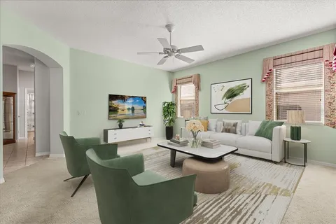 a living room with furniture and a large window