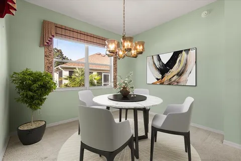 a dining room with furniture and a potted plant