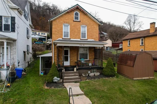 a view of a house with a yard porch and sitting area