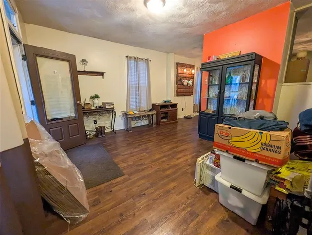 a living room with furniture a fireplace and large windows