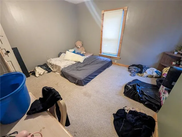 a bedroom with a bed and dresser