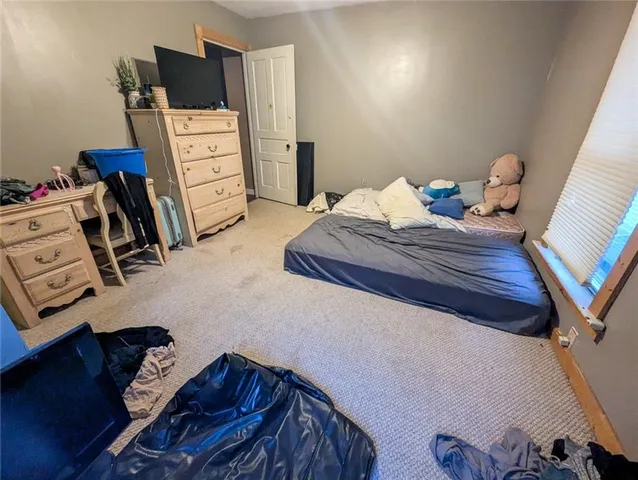 a bedroom with a bed and cabinets
