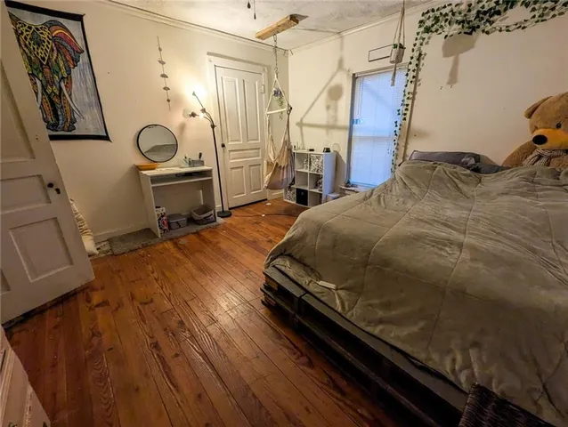 a bed sitting in a bedroom next to a window