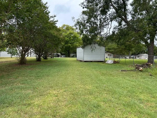 a view of a tree in front of a house