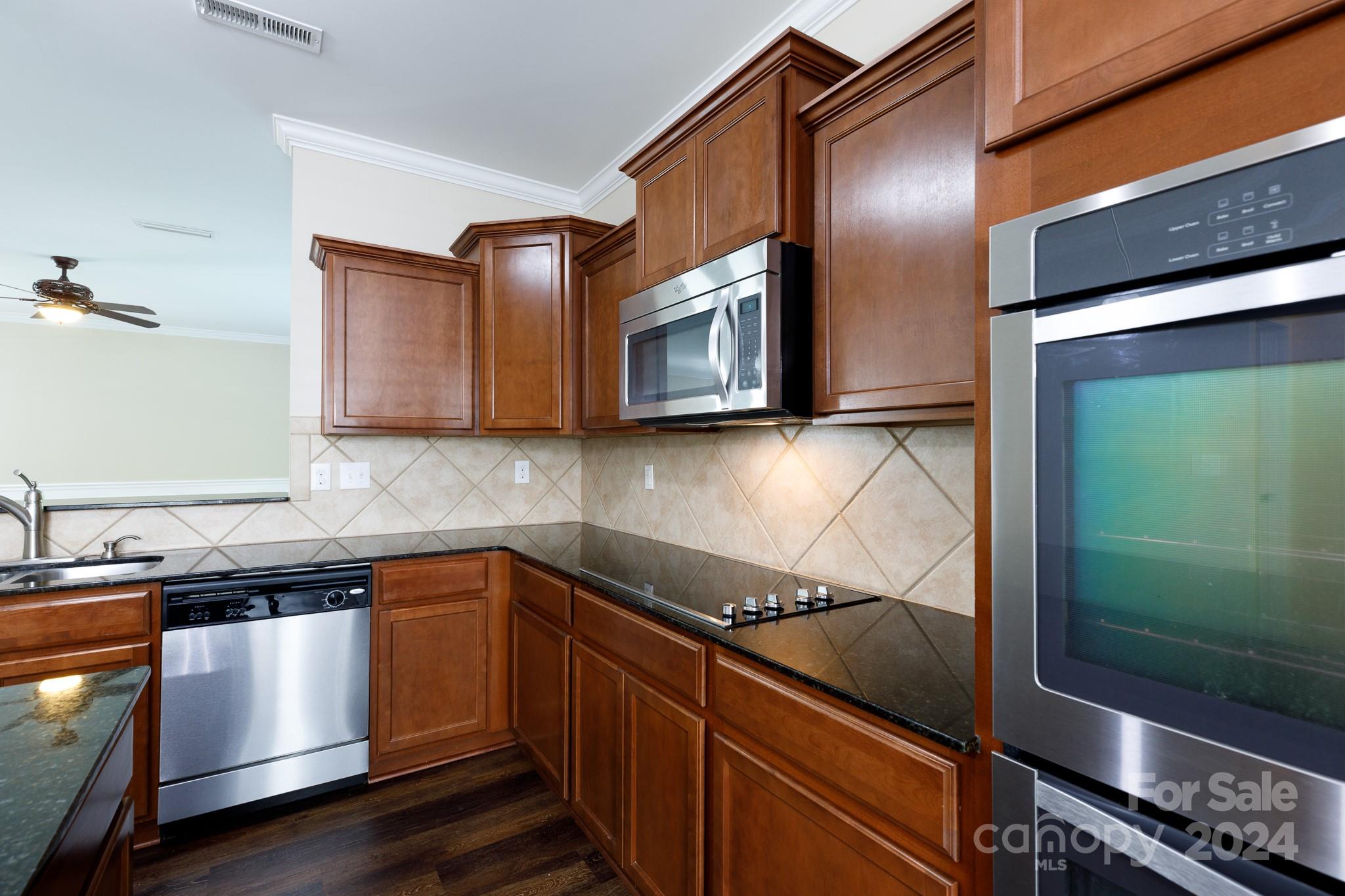 2219 Bluebell Way Fort Mill, SC 29708 - Photo 13 of 48 a kitchen with stainless steel appliances granite countertop a sink and a microwave
