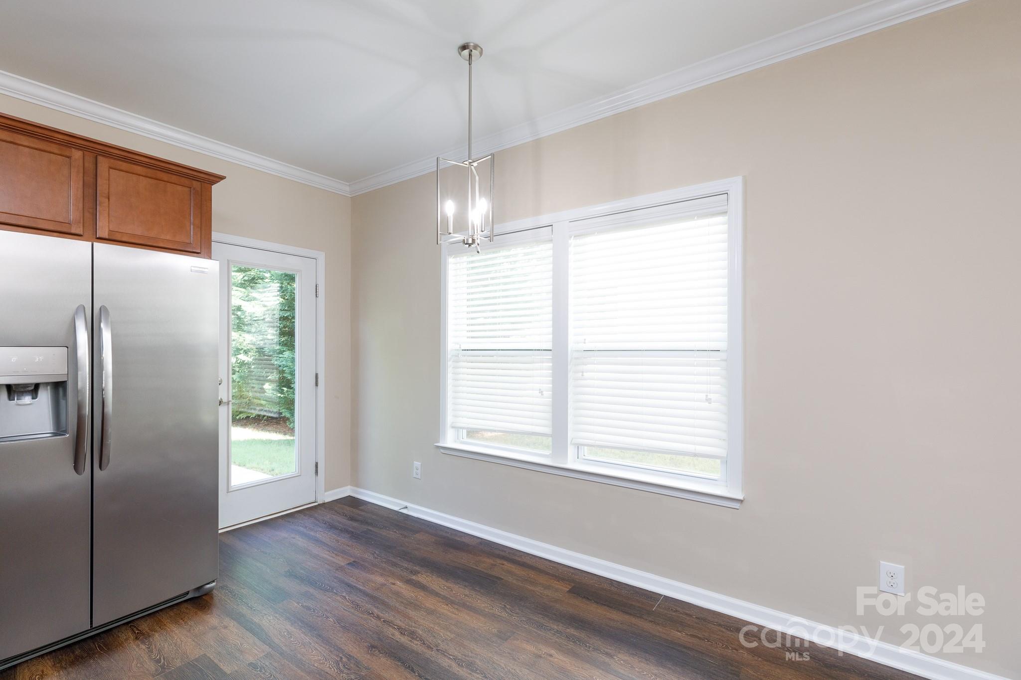 2219 Bluebell Way Fort Mill, SC 29708 - Photo 15 of 48 a view of an empty room with wooden floor fridge and a window