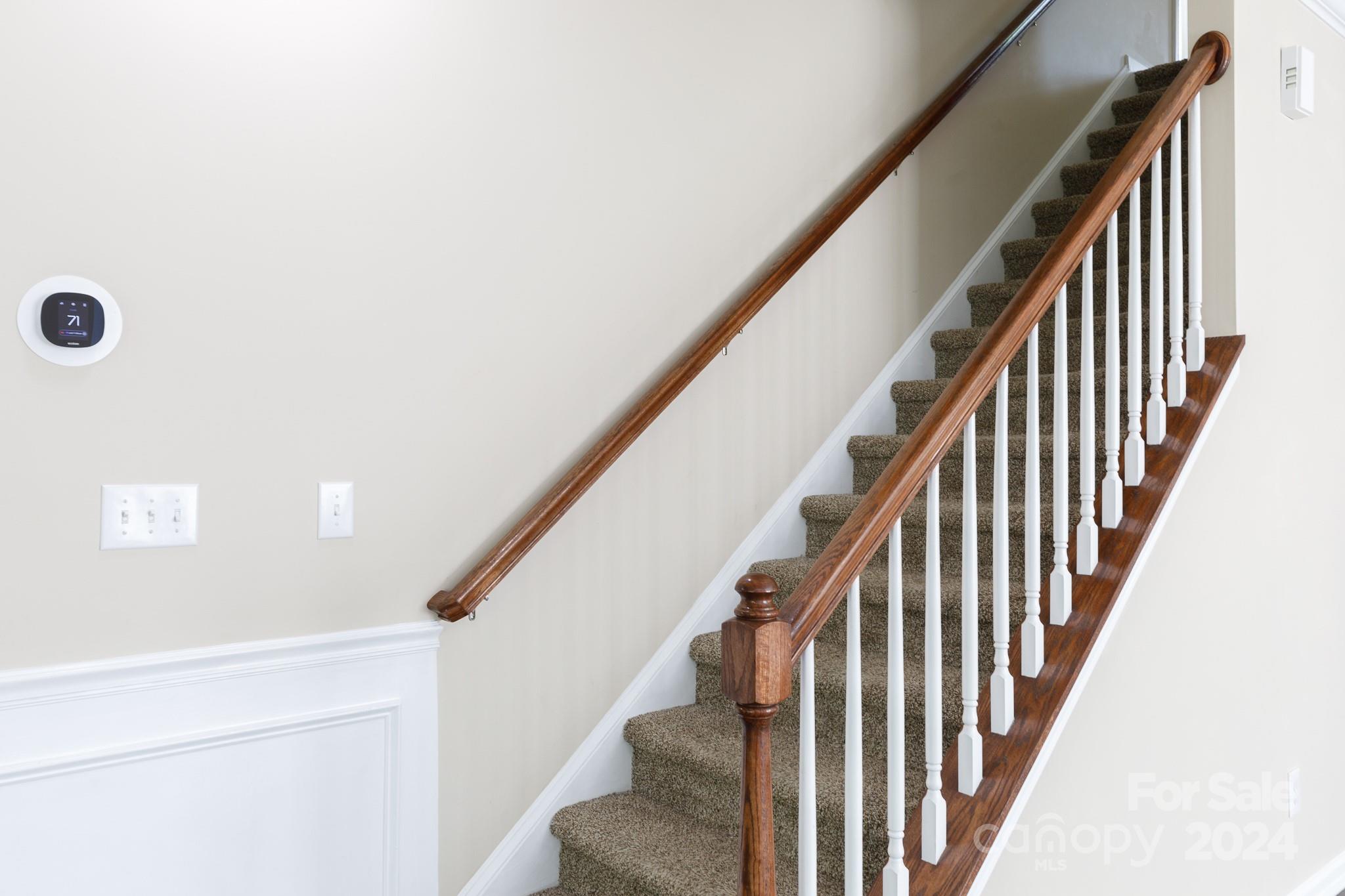 2219 Bluebell Way Fort Mill, SC 29708 - Photo 17 of 48 a view of staircase with railing and white walls