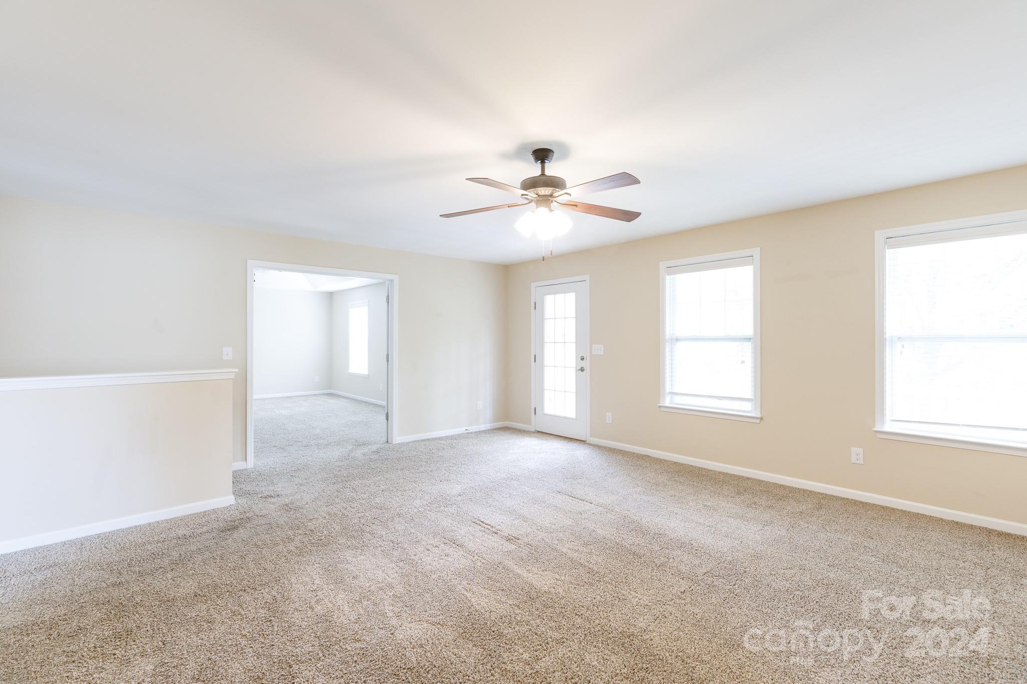 2219 Bluebell Way Fort Mill, SC 29708 - Photo 18 of 48 an empty room with windows and ceiling fan