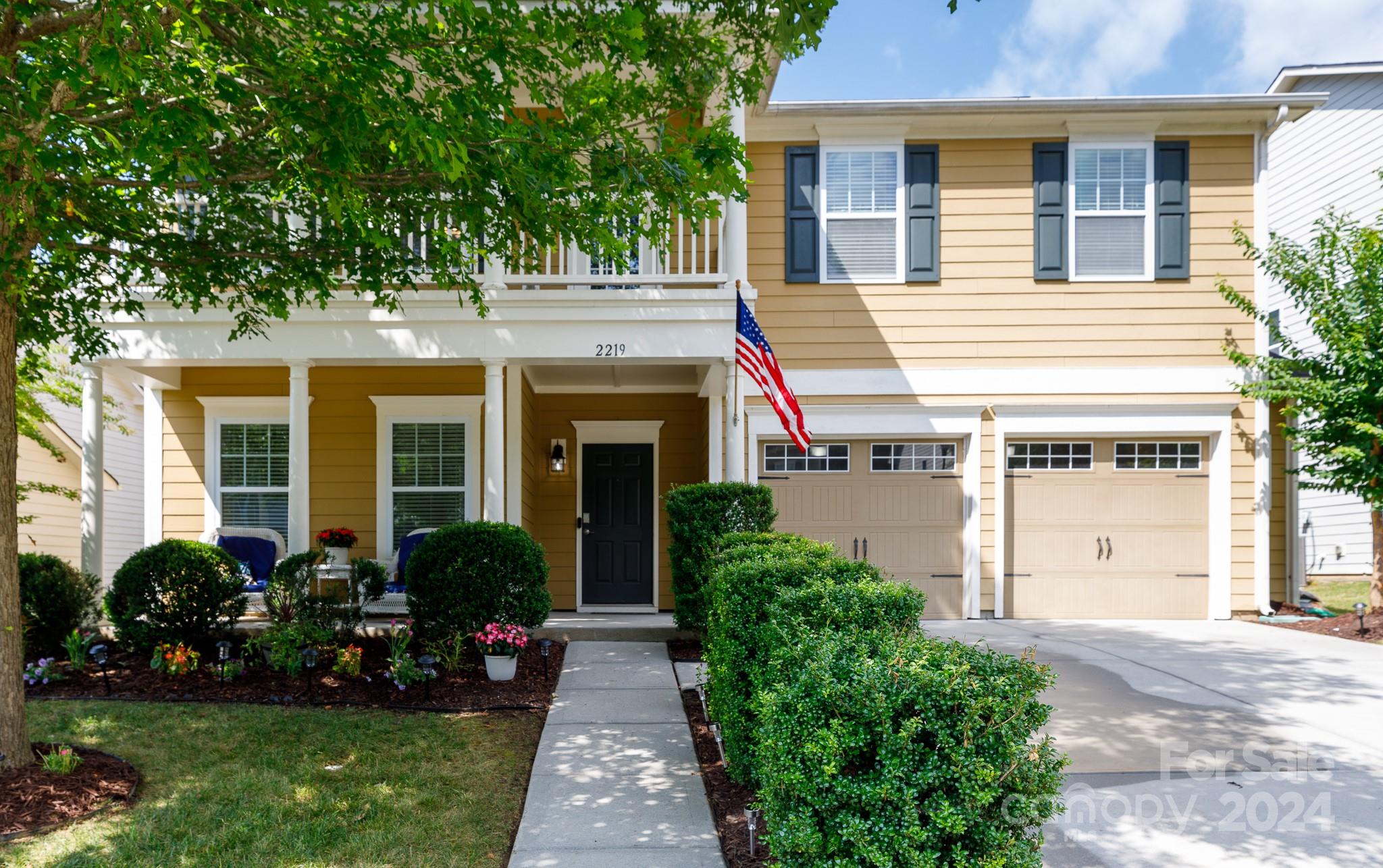 2219 Bluebell Way Fort Mill, SC 29708 - Photo 2 of 48 a front view of a house with a yard and potted plants