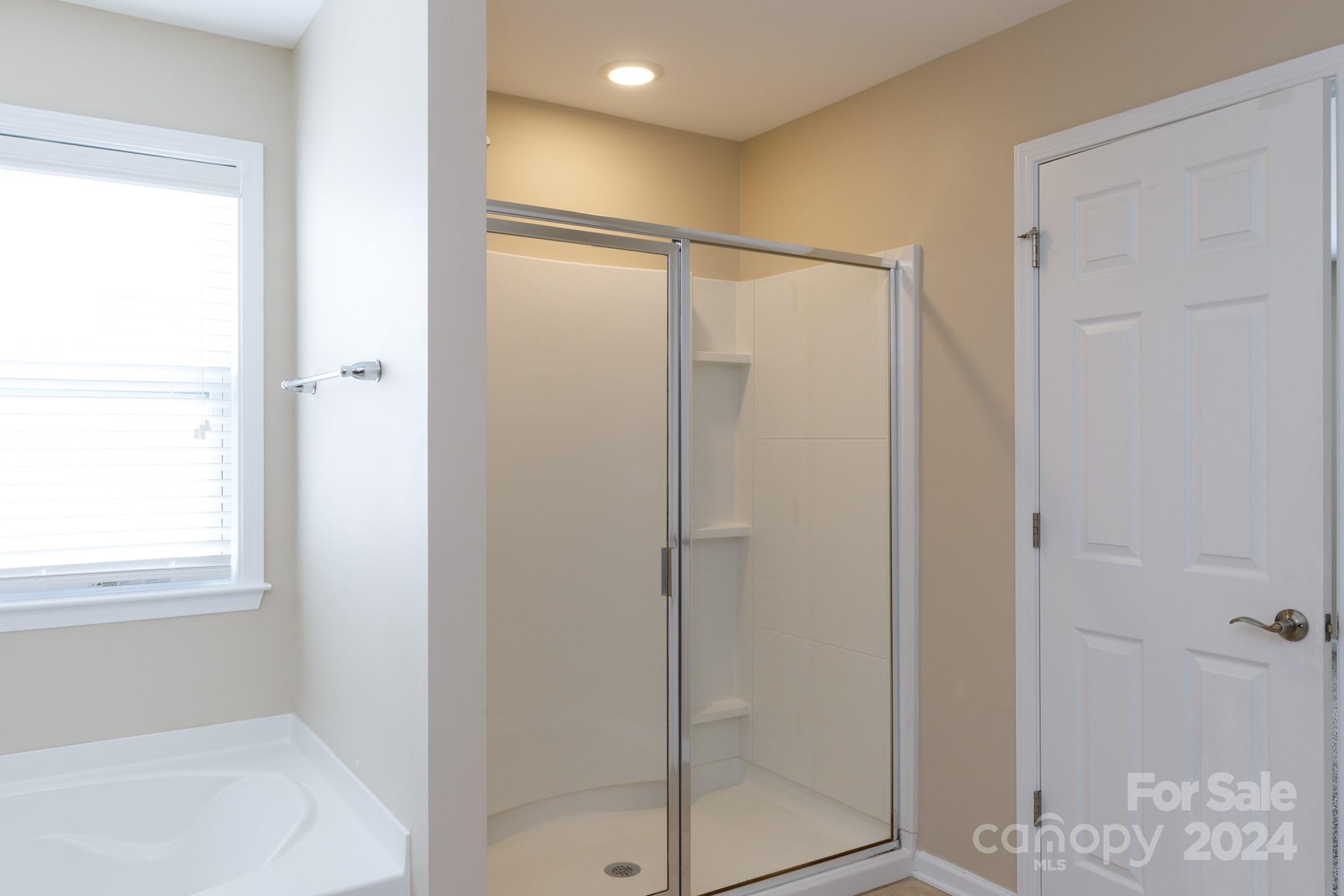 2219 Bluebell Way Fort Mill, SC 29708 - Photo 23 of 48 a bathroom with a glass shower door