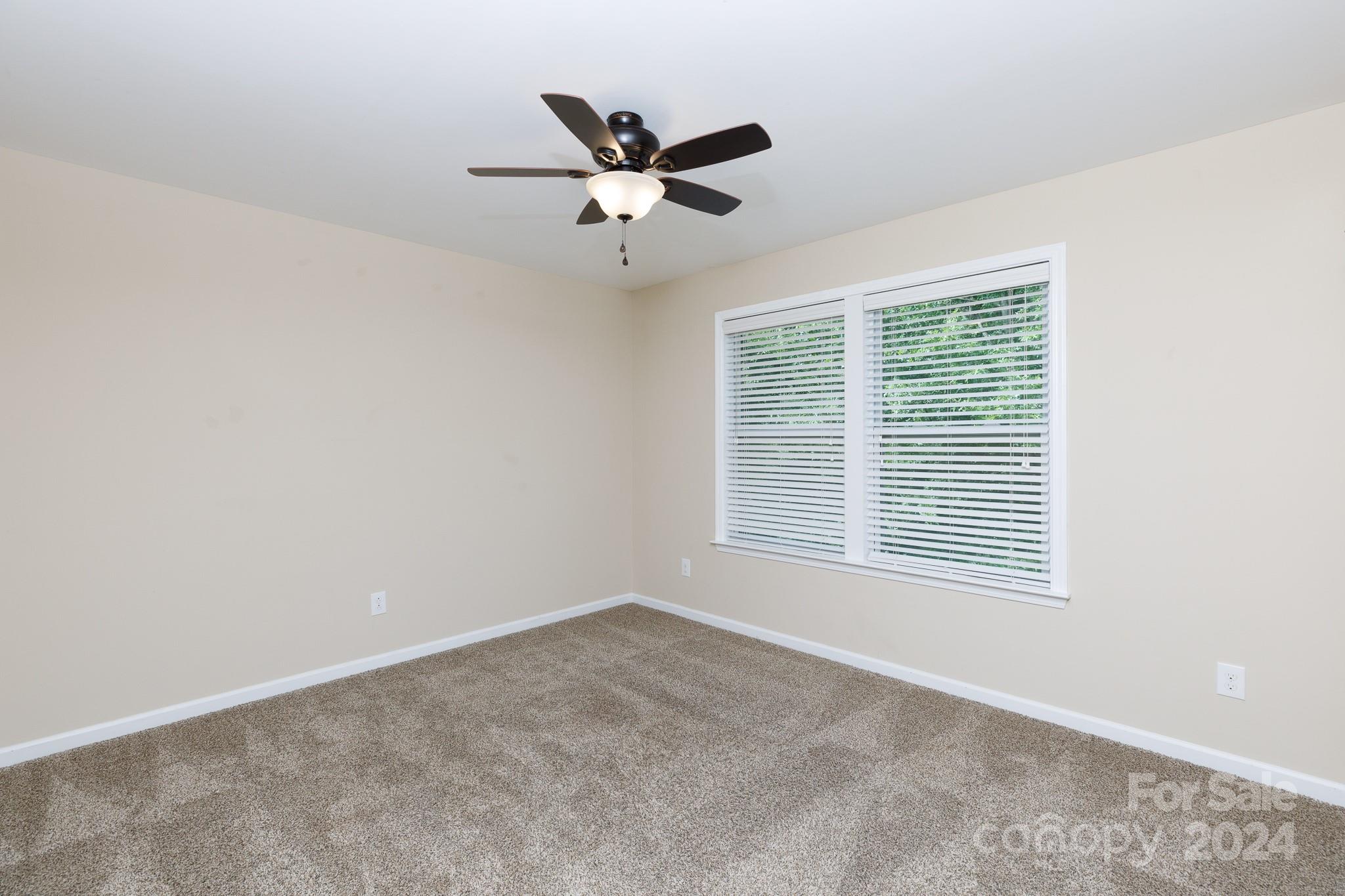2219 Bluebell Way Fort Mill, SC 29708 - Photo 26 of 48 a view of a livingroom with a ceiling fan & windows