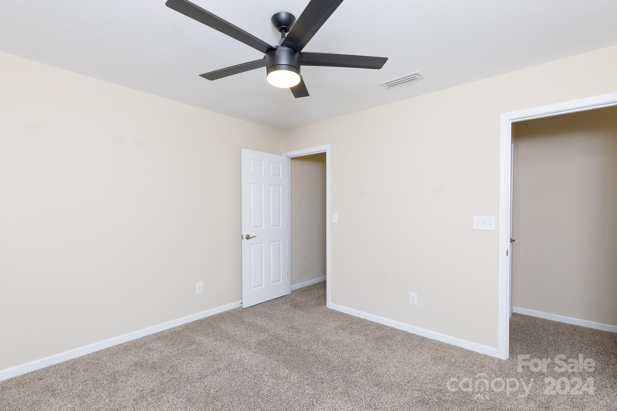 2219 Bluebell Way Fort Mill, SC 29708 - Photo 30 of 48 an empty room with a ceiling fan and a window