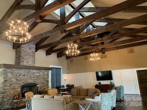 2219 Bluebell Way Fort Mill, SC 29708 - Photo 35 of 48 a living room with furniture a chandelier and a fireplace