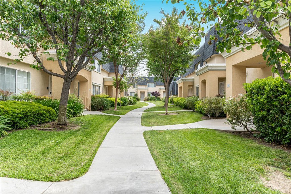 19124 Hamlin Street, Unit 4 Reseda, CA 91335 - Photo 1 of 1 a front view of a house with a yard
