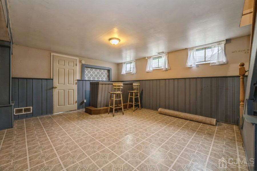 197 Princeton Road Old Bridge, NJ 08859 - Photo 17 of 25 a view of an empty room with wooden walls