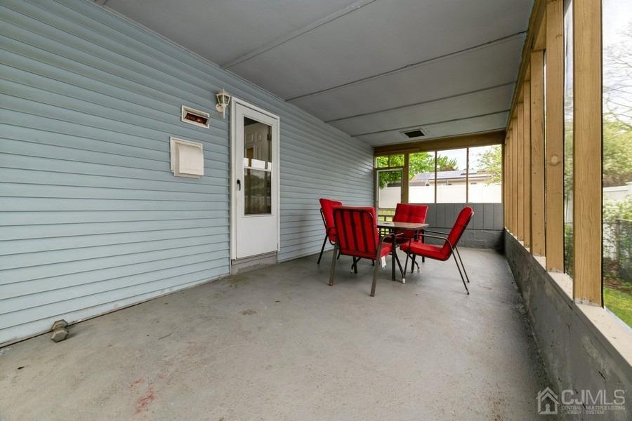 197 Princeton Road Old Bridge, NJ 08859 - Photo 19 of 25 a view of a patio with table and chairs and couches with wooden floor