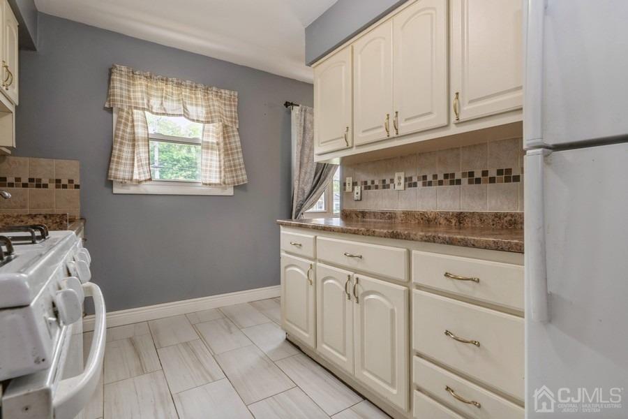 197 Princeton Road Old Bridge, NJ 08859 - Photo 8 of 25 a kitchen with granite countertop white cabinets and white appliances