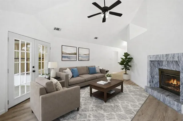 a living room with furniture and a fireplace