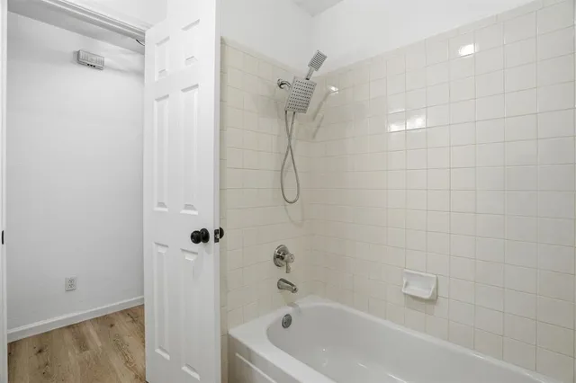 a bathroom with a bath tub with a shower