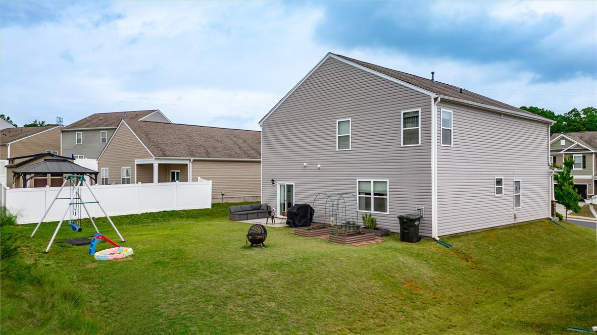 191 Light Spring Road Easley, SC 29642 - Photo 33 of 34 This spacious backyard offers ample green space and a dedicated play area for outdoor enjoyment.