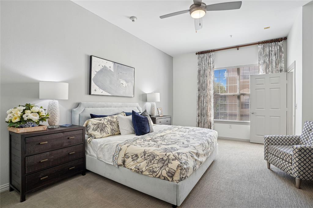 4201 Lomo Alto Drive, Unit 216 Highland Park, TX 75219 - Photo 12 of 31 a bedroom with a bed and ceiling fan