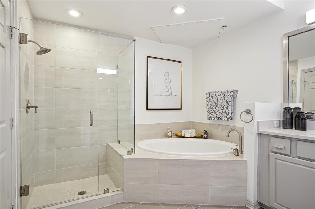4201 Lomo Alto Drive, Unit 216 Highland Park, TX 75219 - Photo 15 of 31 a bathroom with a bathtub shower sink and mirror