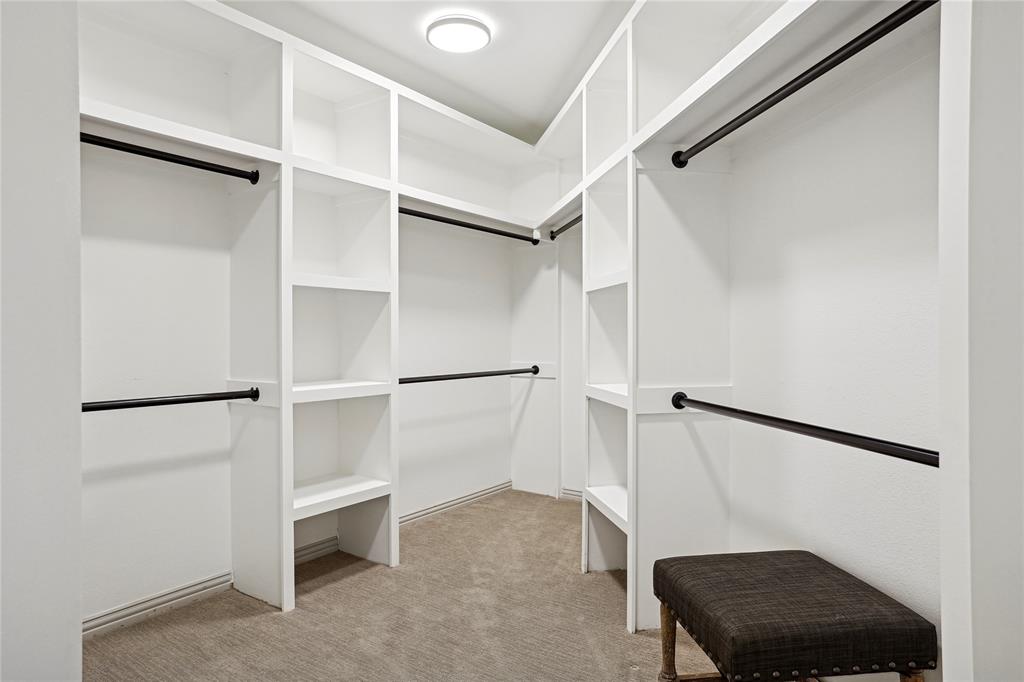 4201 Lomo Alto Drive, Unit 216 Highland Park, TX 75219 - Photo 16 of 31 a view of walk in closet with empty racks