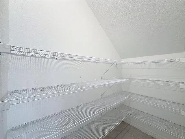 a spacious bedroom with a large bed and a flat screen tv