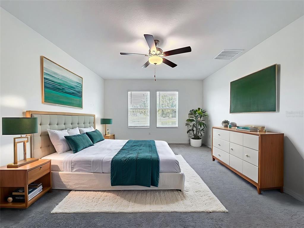 4395 Trotters Way Lakeland, FL 33801 - Photo 15 of 67 a spacious bedroom with a large bed and a flat screen tv