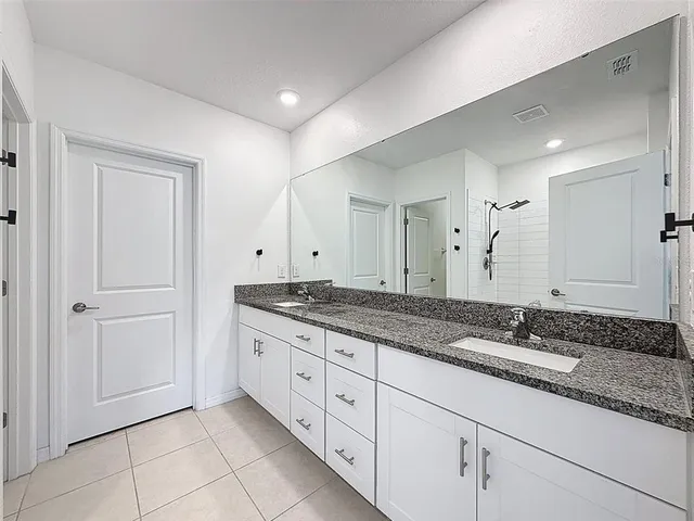 a bedroom with a bed and a potted plant