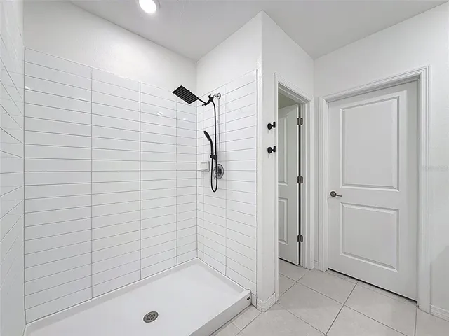 an empty room with ceiling fan and window