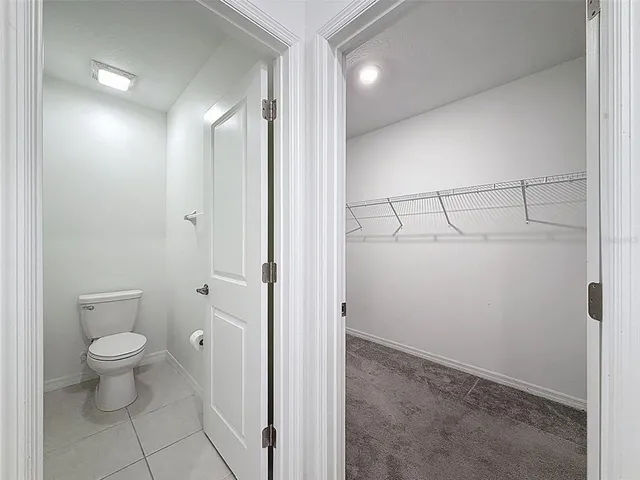 a bathroom with a granite countertop toilet a sink and bathtub