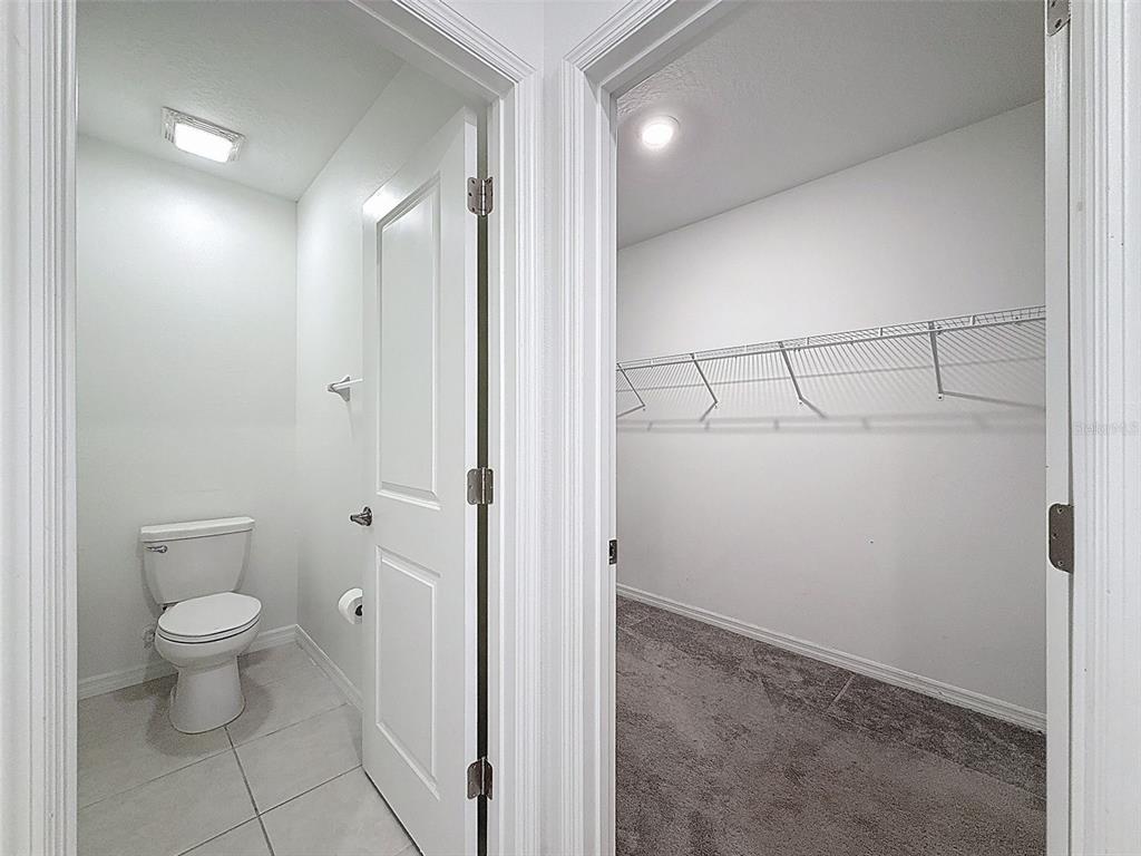 4395 Trotters Way Lakeland, FL 33801 - Photo 20 of 67 a bathroom with a granite countertop toilet and a shower