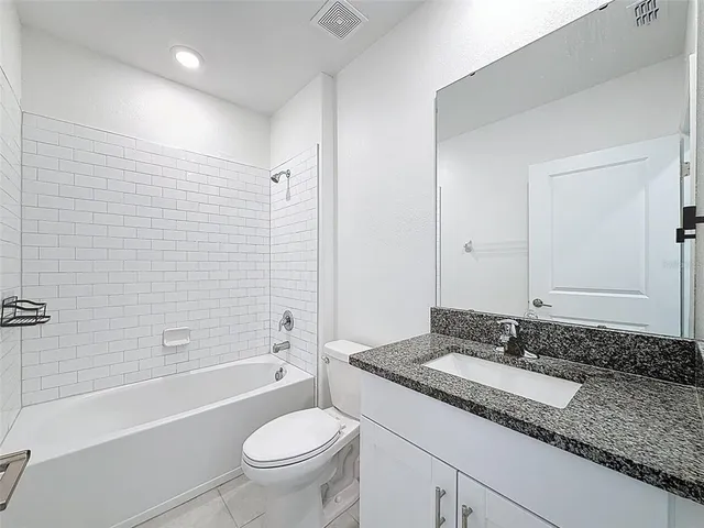 a view of an empty room with a ceiling fan