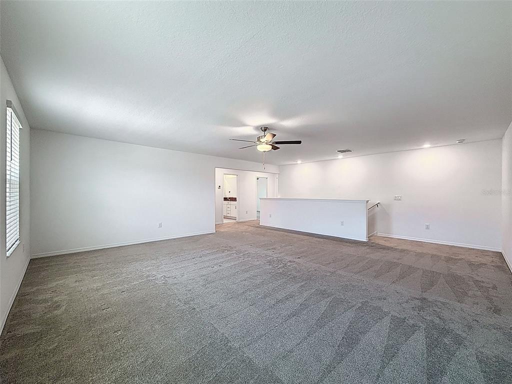 4395 Trotters Way Lakeland, FL 33801 - Photo 33 of 67 an empty room with a ceiling fan and window