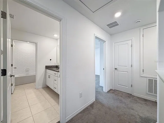 an aerial view of a house with a garden and lake view