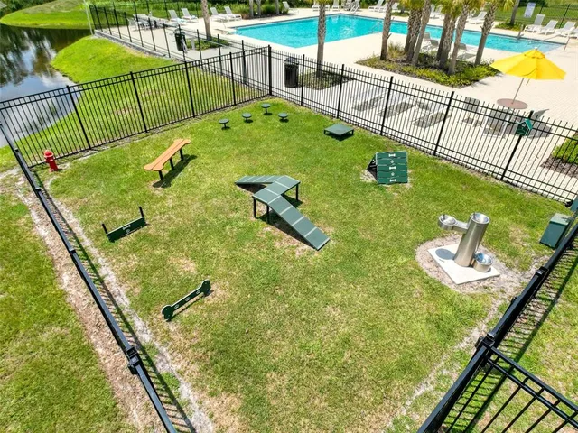 a large kitchen with stainless steel appliances granite countertop a sink and white cabinets