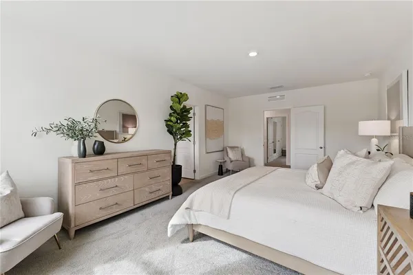 a bedroom with a bed and a couch