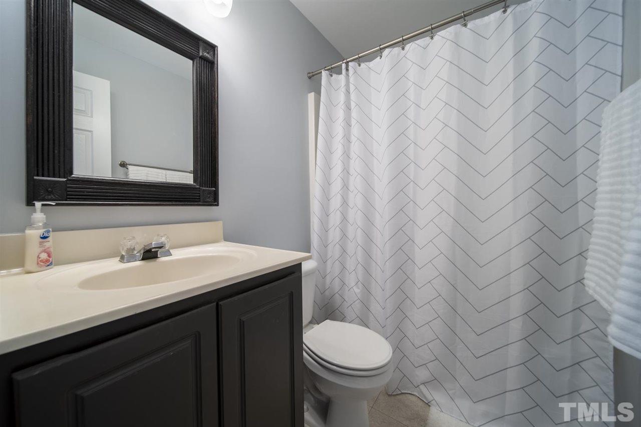 4817 Mistletoe Lane Durham, NC 27703 - Photo 13 of 15 a bathroom with a sink and a mirror
