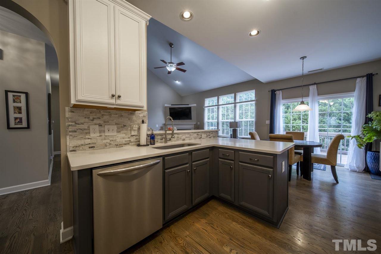 4817 Mistletoe Lane Durham, NC 27703 - Photo 7 of 15 a kitchen with a sink stove and cabinets