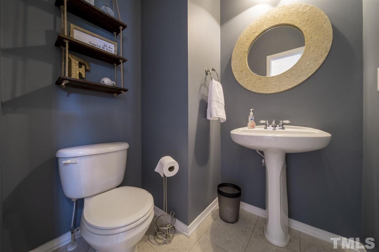 4817 Mistletoe Lane Durham, NC 27703 - Photo 9 of 15 a bathroom with a toilet sink and mirror