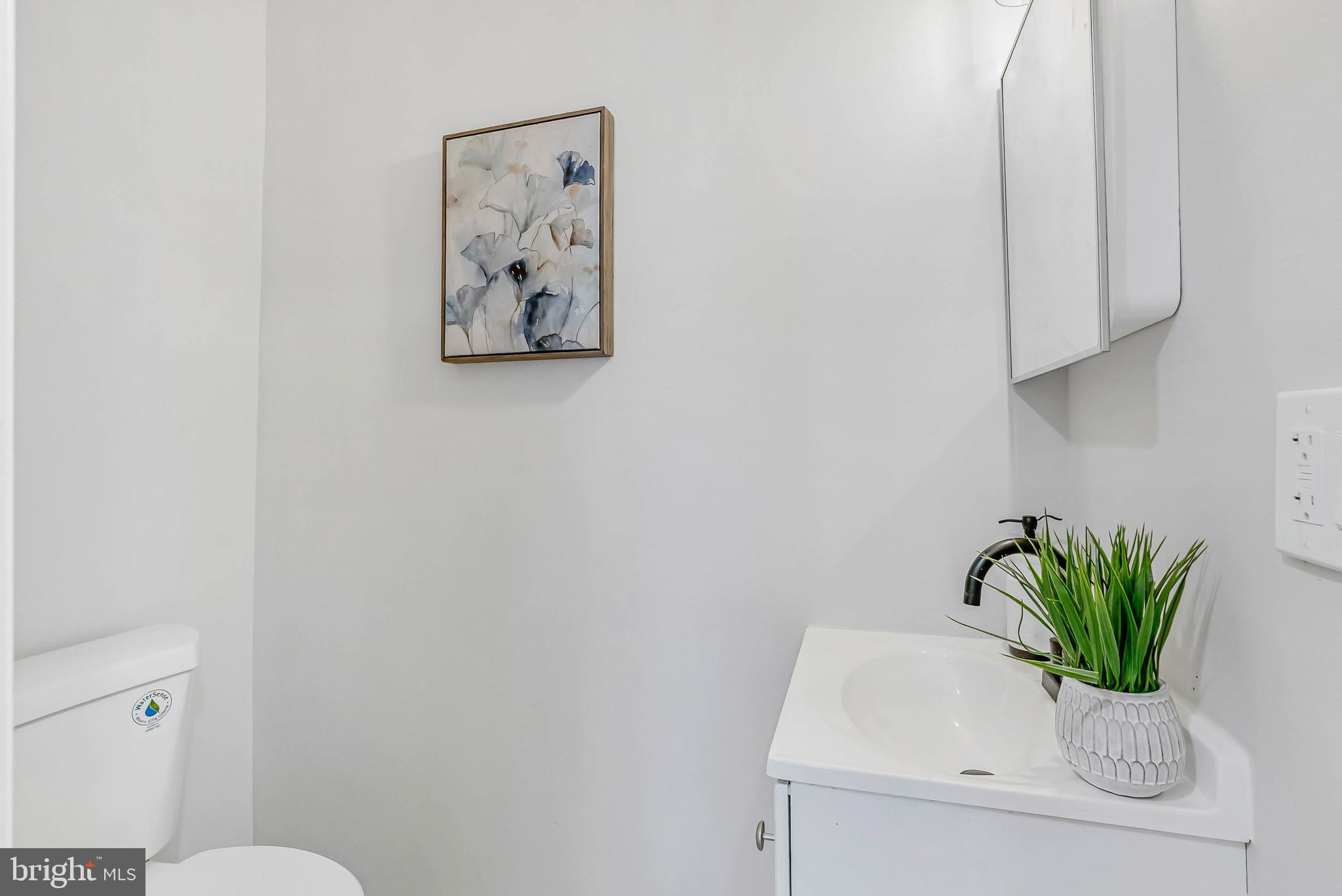 2839 Winton Street Philadelphia, PA 19145 - Photo 5 of 20 a white painted wall with a sink and a mirror