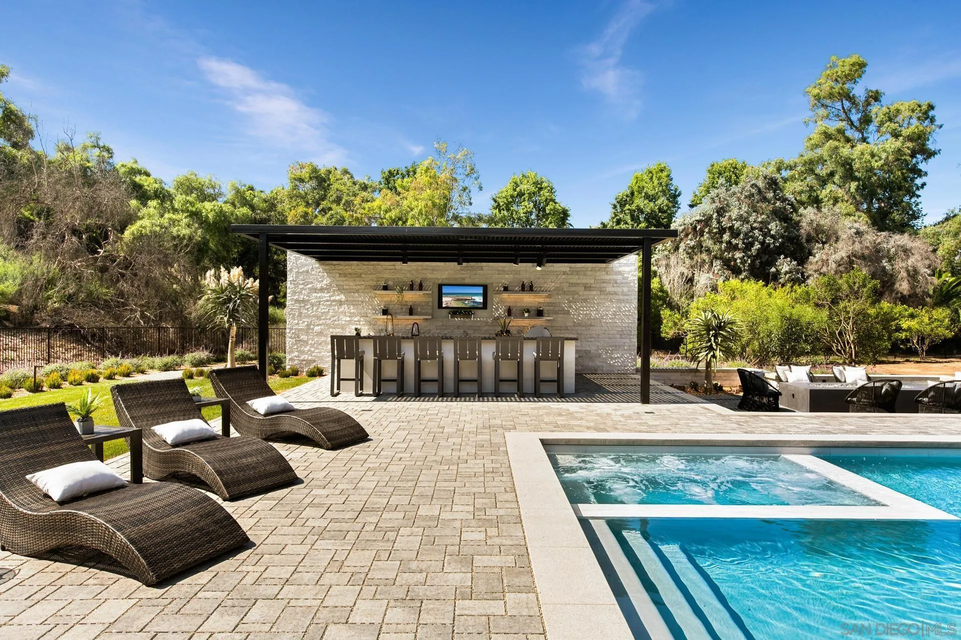 16073 Via Monte Rancho Santa Fe, CA 92067 - Photo 33 of 62 a view of a patio with couches and a table and chairs with wooden floor