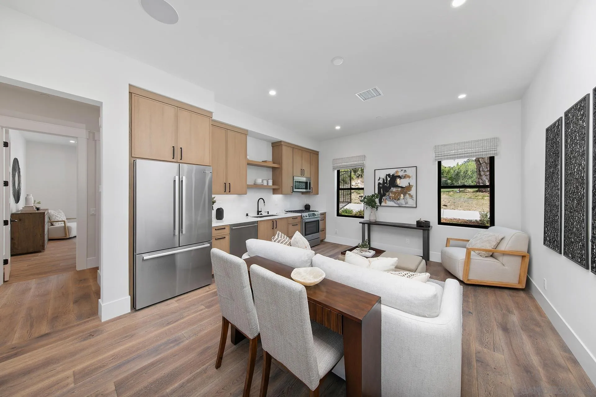 16073 Via Monte Rancho Santa Fe, CA 92067 - Photo 59 of 62 a kitchen with stainless steel appliances a dining table chairs refrigerator sink and cabinets