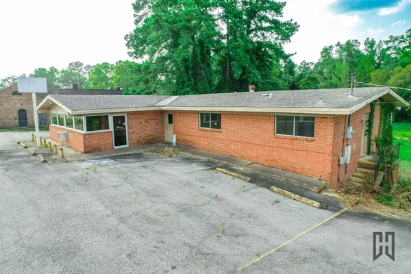 a view of house with a yard and front area
