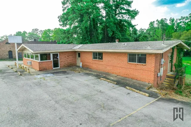 a view of house with a yard and front area