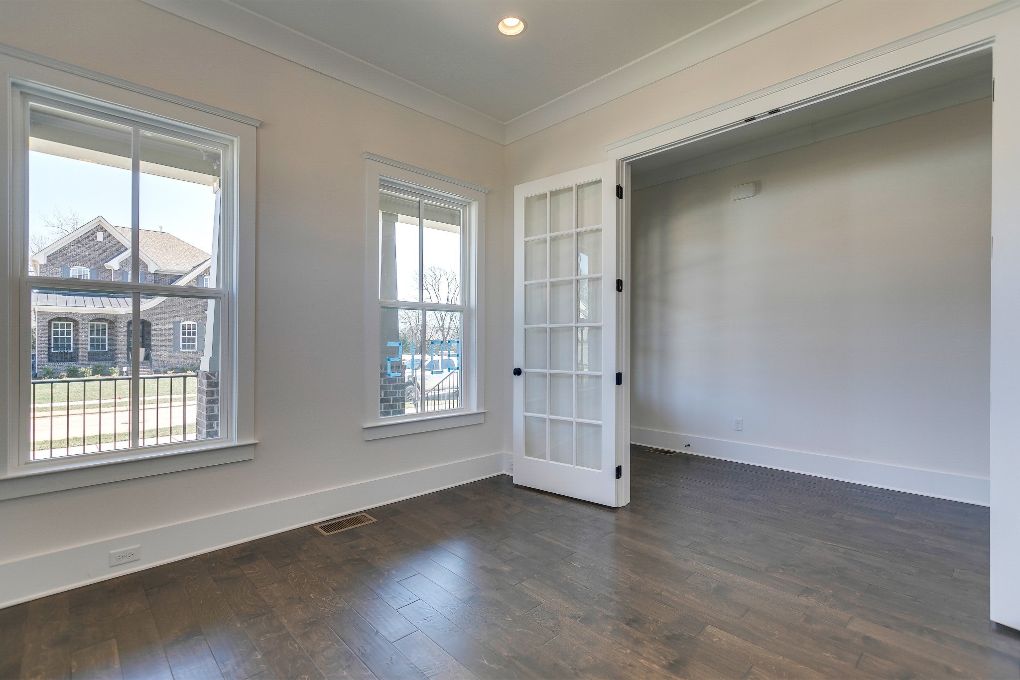 392 Dewar Drive Franklin, TN 37064 - Photo 5 of 13 an empty room with wooden floor and windows