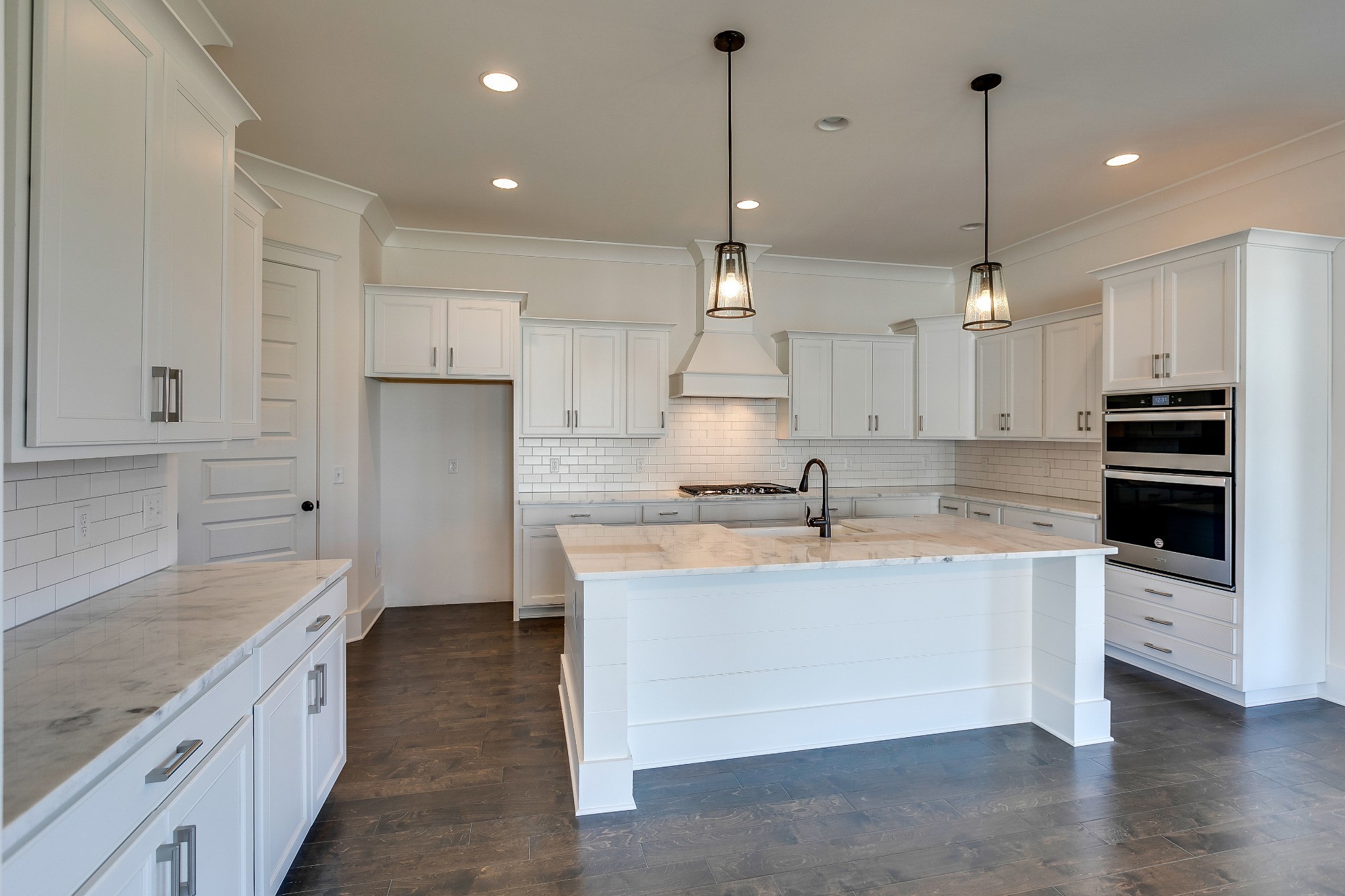 392 Dewar Drive Franklin, TN 37064 - Photo 6 of 13 a large kitchen with stainless steel appliances kitchen island granite countertop a sink a stove and a refrigerator